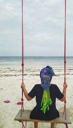 Full length of boy on beach against sky