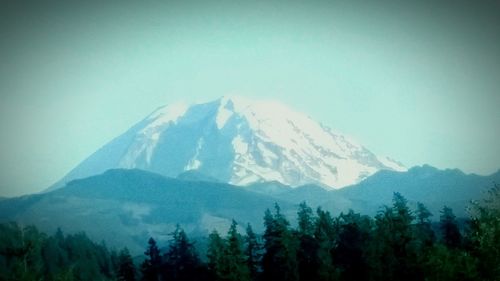 Scenic view of mountains against cloudy sky