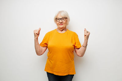 Portrait of woman gesturing against white background