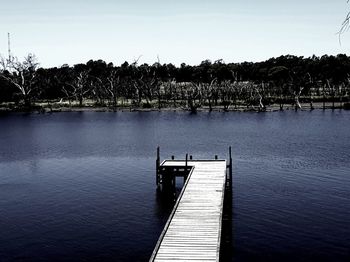 Pier on lake against sky