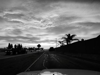 Road against sky seen through car windshield