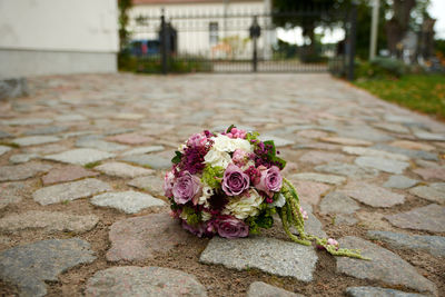 Close-up of rose bouquet on footpath