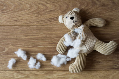 High angle view of damaged teddy bear on table