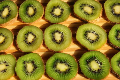 Full frame shot of kiwi fruits arranged on table