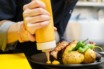 Midsection of man preparing food