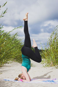 Full length of woman on beach against sky