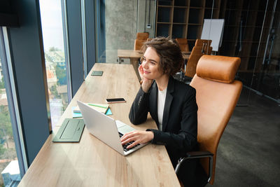 Young woman using laptop on table