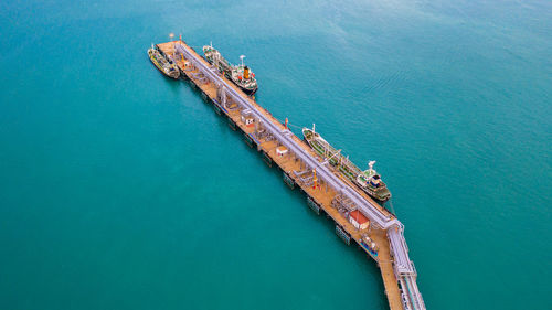 Aerial view of ship by pier over sea