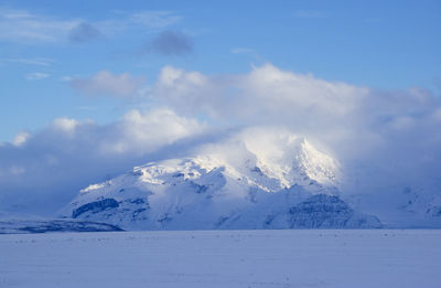 Scenic view of snowcapped mountain against sky