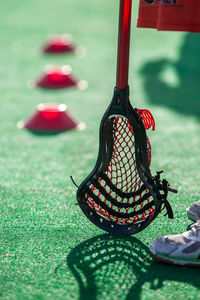 Low section of player with lacrosse sports equipment