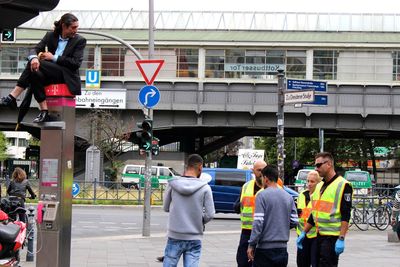 Rear view of people standing on railroad station platform