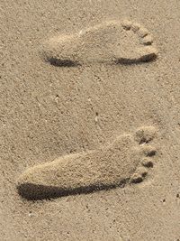 High angle view of footprints on sand