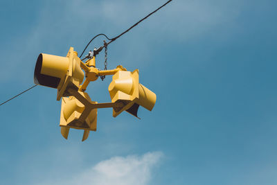 Low angle view of road light against blue sky