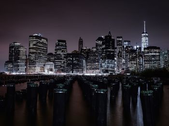 Illuminated cityscape against clear sky at night