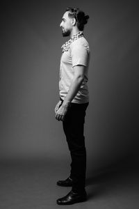 Full length of young man standing against white background