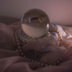 Close-up of crystal ball on bed