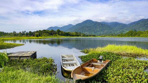 Scenic view of lake and mountains against sky