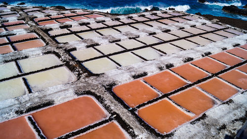 High angle view of salt flat sea salk farm water fields multicolour texture background 