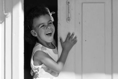 Smiling girl standing at door 