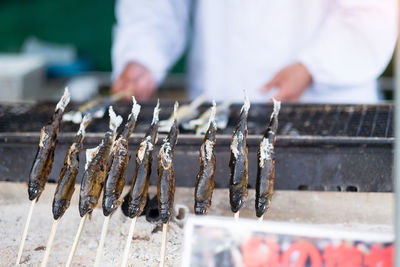 Man preparing food on barbecue grill