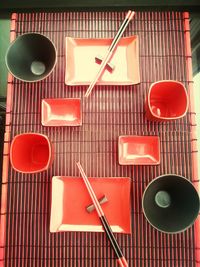 Close-up of empty red objects on tiled floor