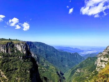 Scenic view of mountains against blue sky