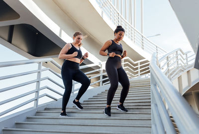 Full length of young woman exercising in gym