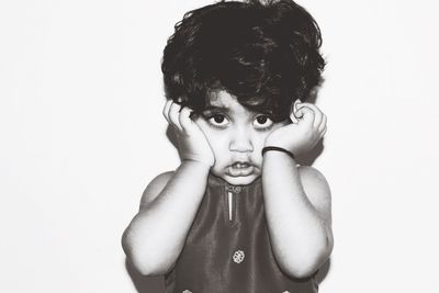 Portrait of cute girl against white background