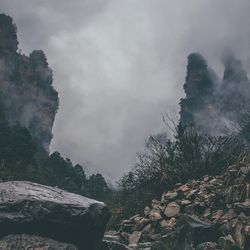 Scenic view of mountains against cloudy sky
