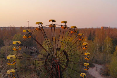 Ferris wheel against sky during sunset