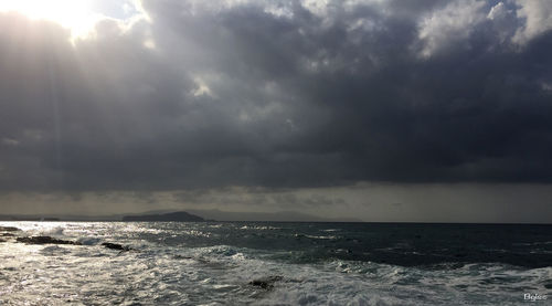 View of calm sea against cloudy sky