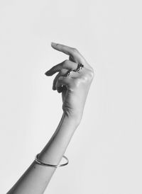 Midsection of person holding hands against white background