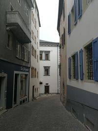 Empty alley amidst buildings in city