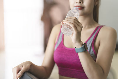 Midsection of a woman drinking glass