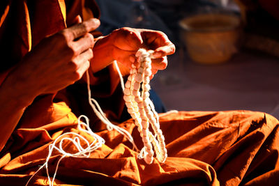 Close-up of hand holding orange