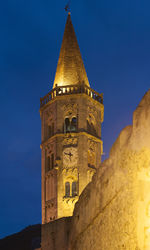 Low angle view of clock tower against clear blue sky