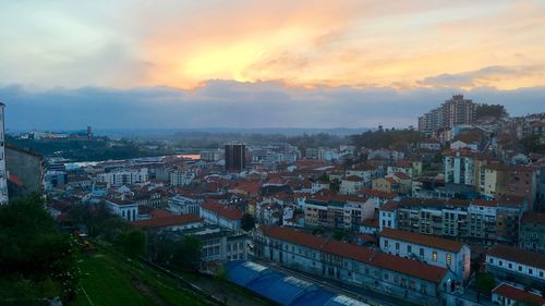 View of cityscape against cloudy sky