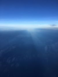 Aerial view of sea against blue sky