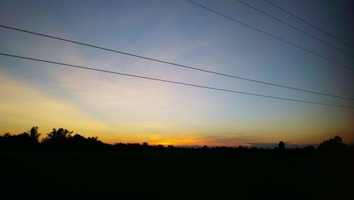 Silhouette landscape against sky during sunset