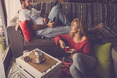 Smiling couple enjoying at home