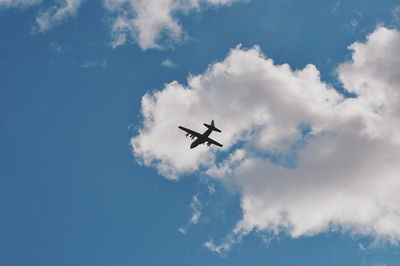 Low angle view of airplane flying in sky