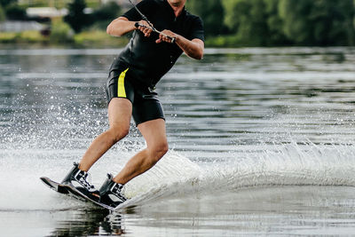 Full length of man splashing water