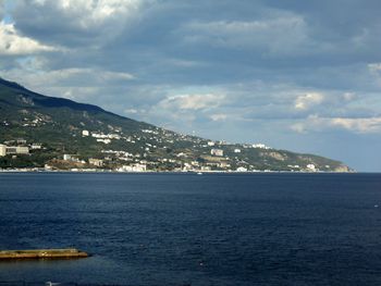 View of calm sea against cloudy sky