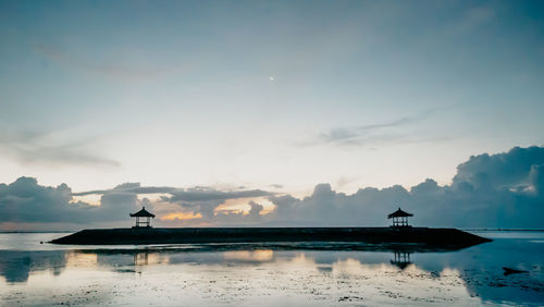 Silhouette boat in sea against sky during sunset