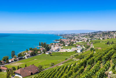 High angle view of townscape by sea against sky