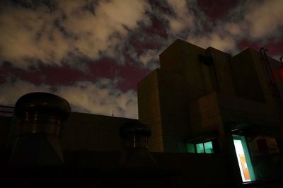 Low angle view of building against cloudy sky