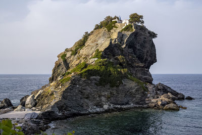 The chapel of st john the baptist sits on the top of the rock off the island of skopelos in greece.