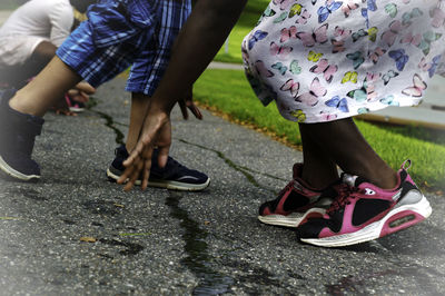 Low section of people walking on street