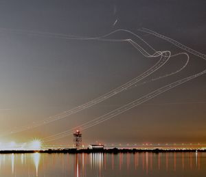 Scenic view of lake against sky at night