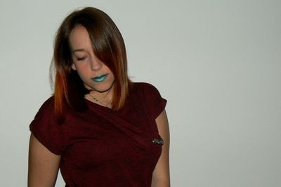 Close-up of young woman against white background